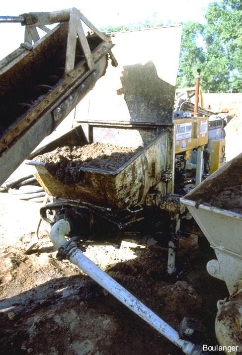 Grout is placed in the hopper of the pump. (Courtesy of Dr. Ross Boulanger, UC Davis).