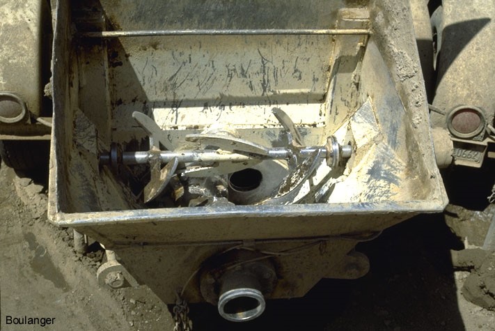 Paddles in the hopper of the grout pump thoroughly mix the grout materials. (Courtesy of Dr. Ross Boulanger, UC Davis).