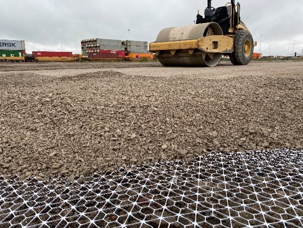 Photograph of compaction of materials over InterAx geogrid. 