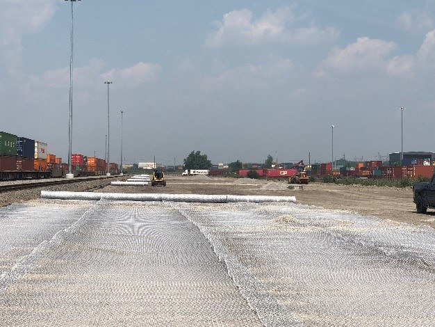 Photograph of rolling out geogrid materials. 