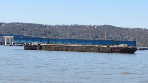 Barges haul deck girders for the new bridge.